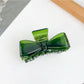 Beau minimalist bow claw clip with smooth matte finish on neutral background