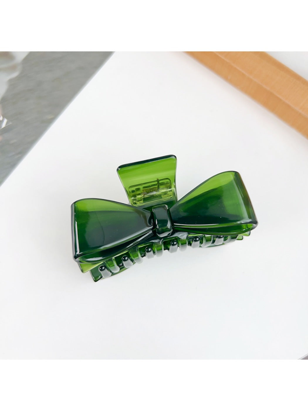 Beau minimalist bow claw clip with smooth matte finish on neutral background