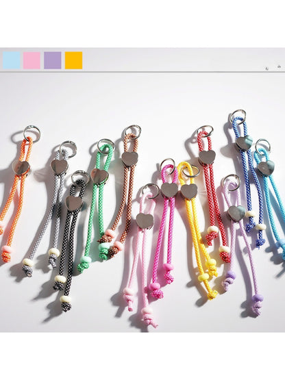 Colorful rope heart keychain with vibrant twisted strands on white background