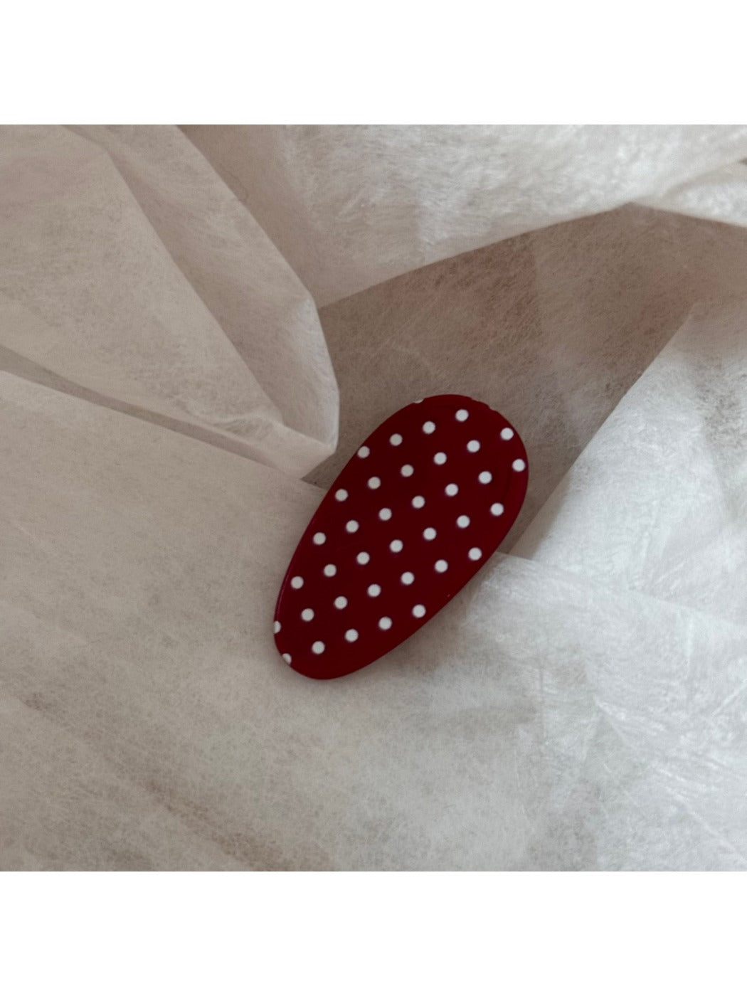 Beau hair clip placed on a white surface displaying full design