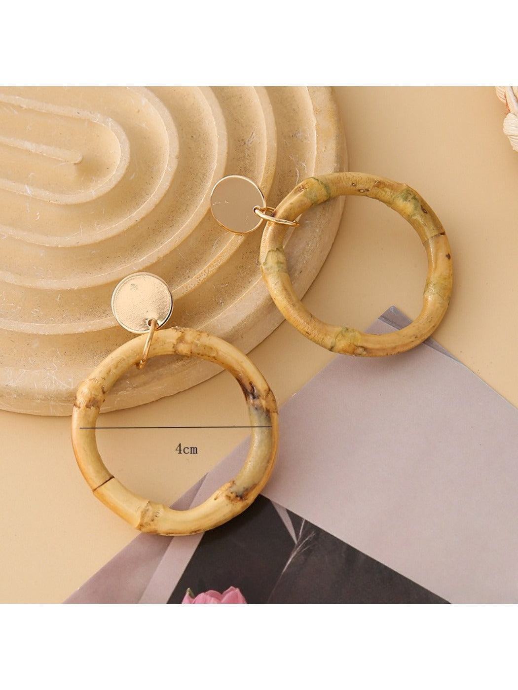 Side view of Earedge woven rattan round hollow earrings showing texture