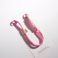 Brightly colored rope keychain with silver ring on wooden table