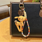 Keypus deer charm keychain attached to a set of keys on a desk