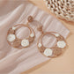 Sweet Raffia Circle Stud Earrings arranged with natural raffia fibers