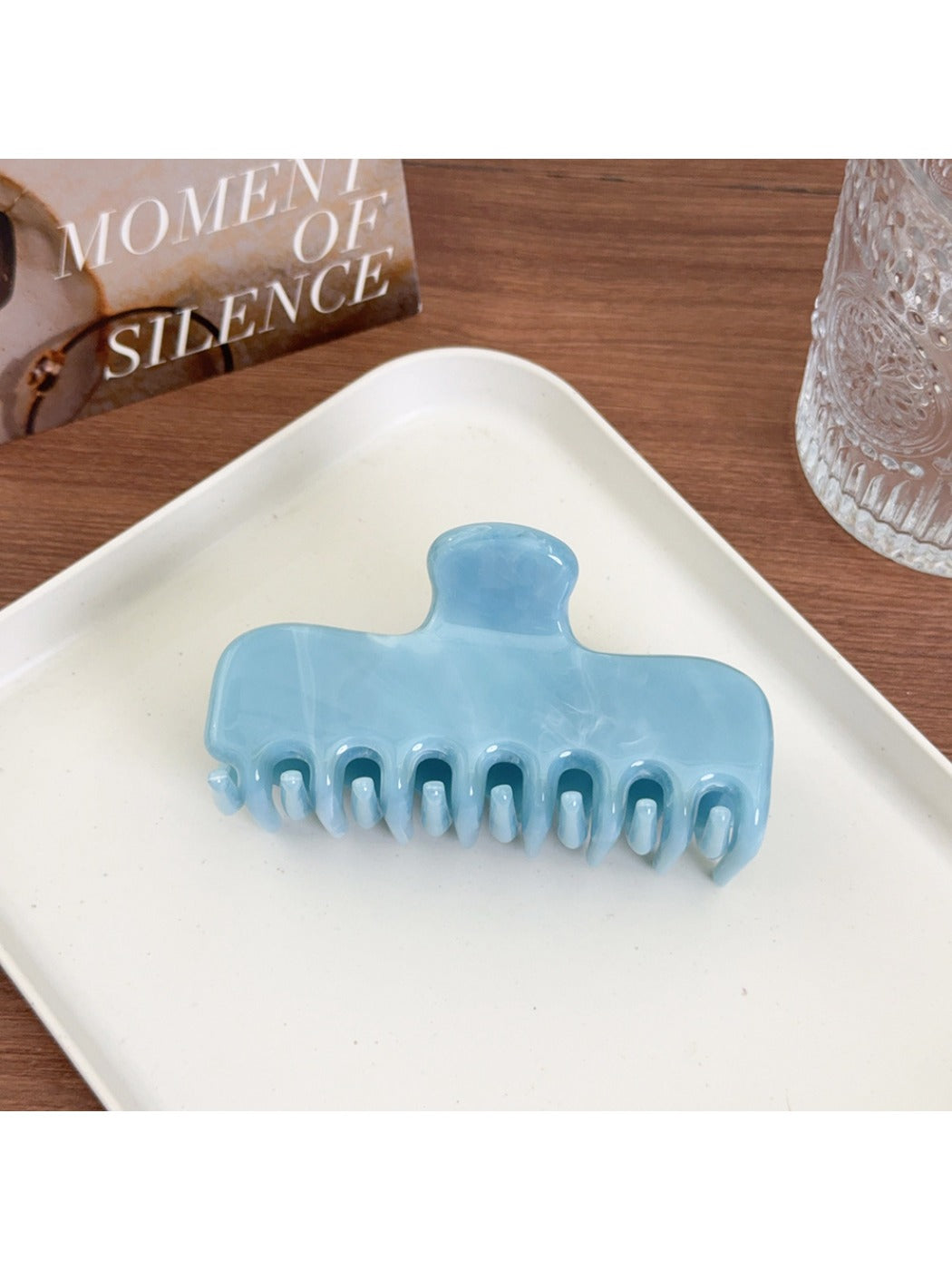 Beau hair claw clip holding a section of brown hair in a half-up style