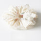 Gifty scrunchie laid flat to showcase full printed fabric and ruched design