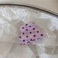 Beau pink polka dot hair clip styled in a ponytail