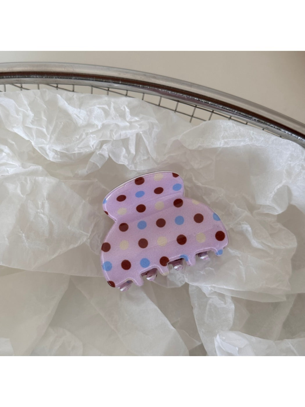 Beau pink polka dot hair clip styled in a ponytail