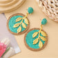 Earedge round leaf pendant earrings photographed with natural lighting
