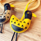 Side view of the little ostrich keychain highlighting its curved neck