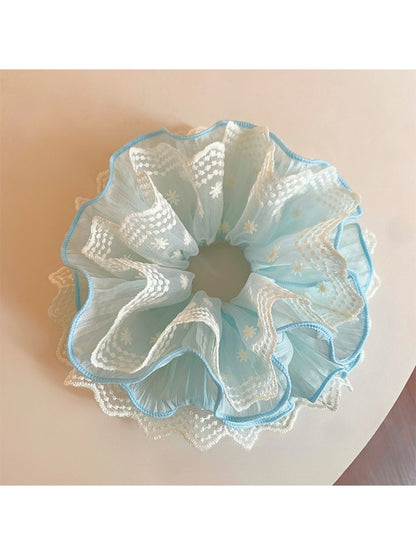 Blue lace scrunchie alongside matching blue lace fabric swatches