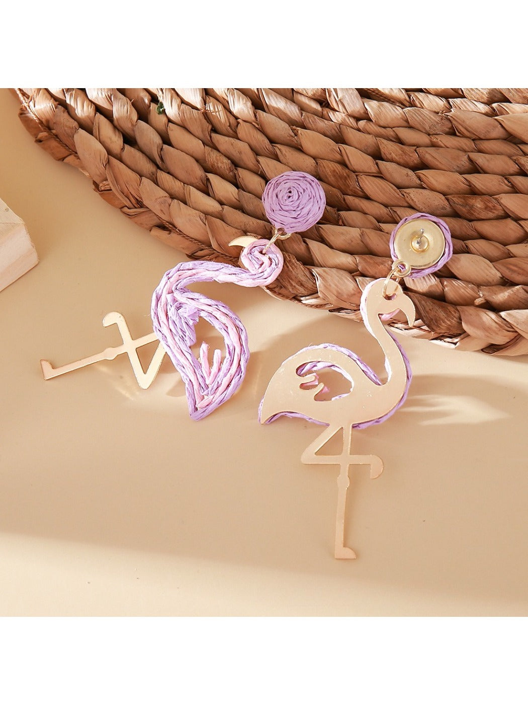 Pair of cute flamingo pendant earrings displayed on a jewelry card