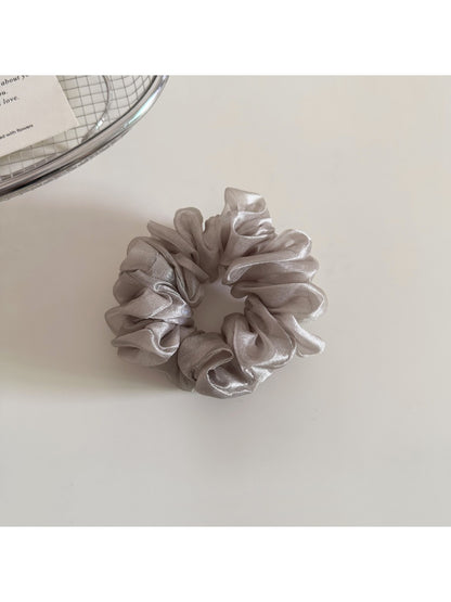 Model wearing a solid color scrunchie styled with casual outfit