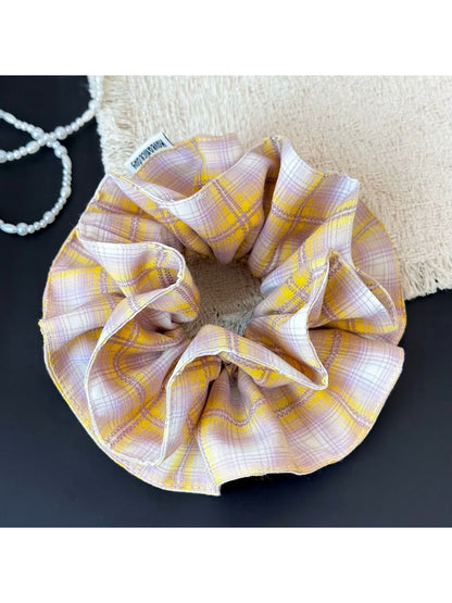 Yellow plaid scrunchie paired with casual outfit on model