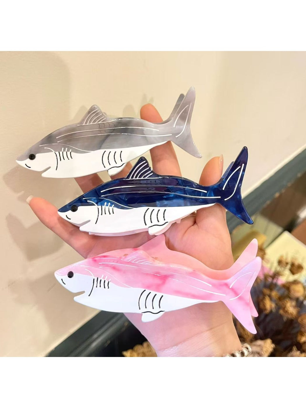 Top view of Beau shark shape claw clip highlighting curved jaw and teeth