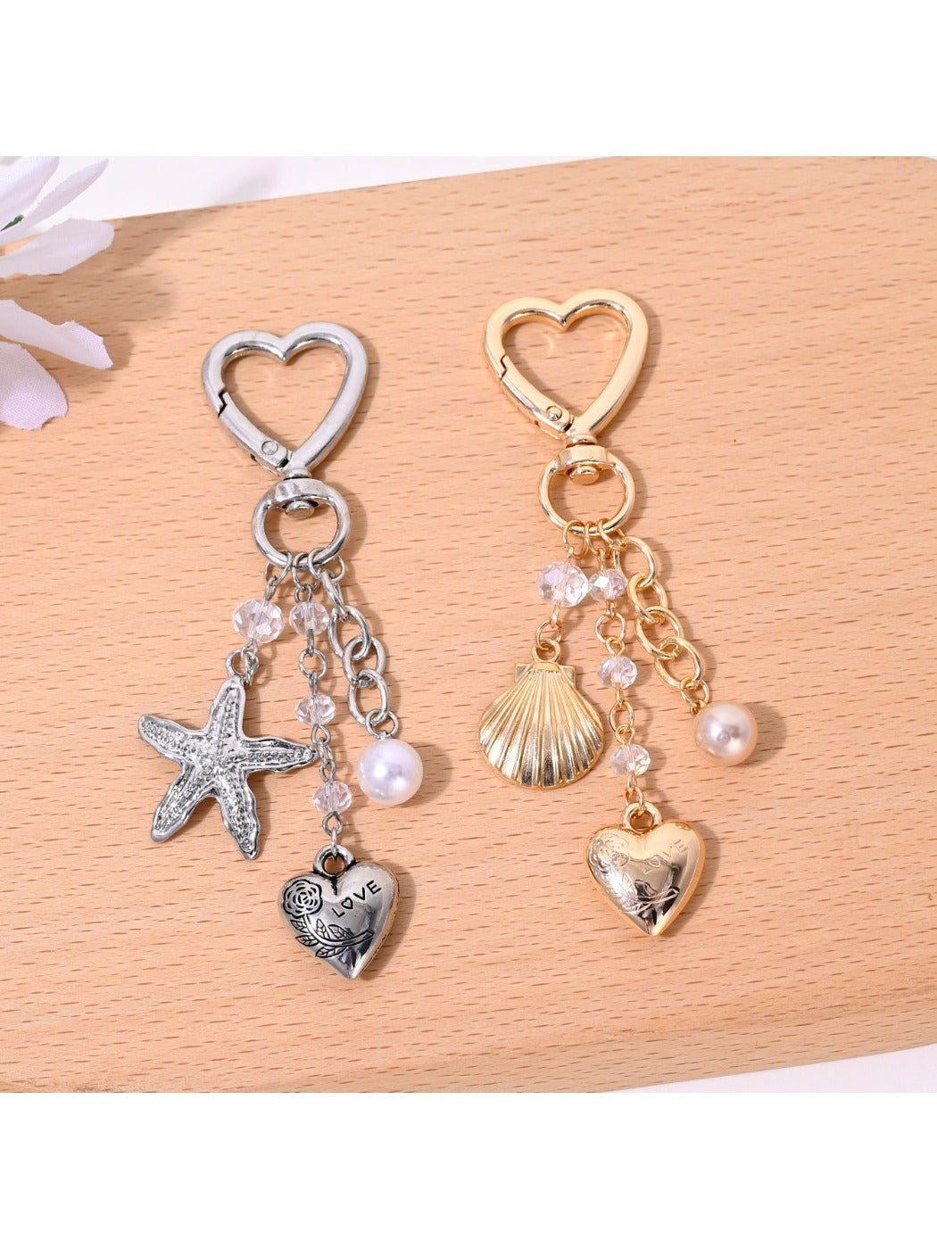Starfish shaped heart keychain in rose gold metal with engraved details