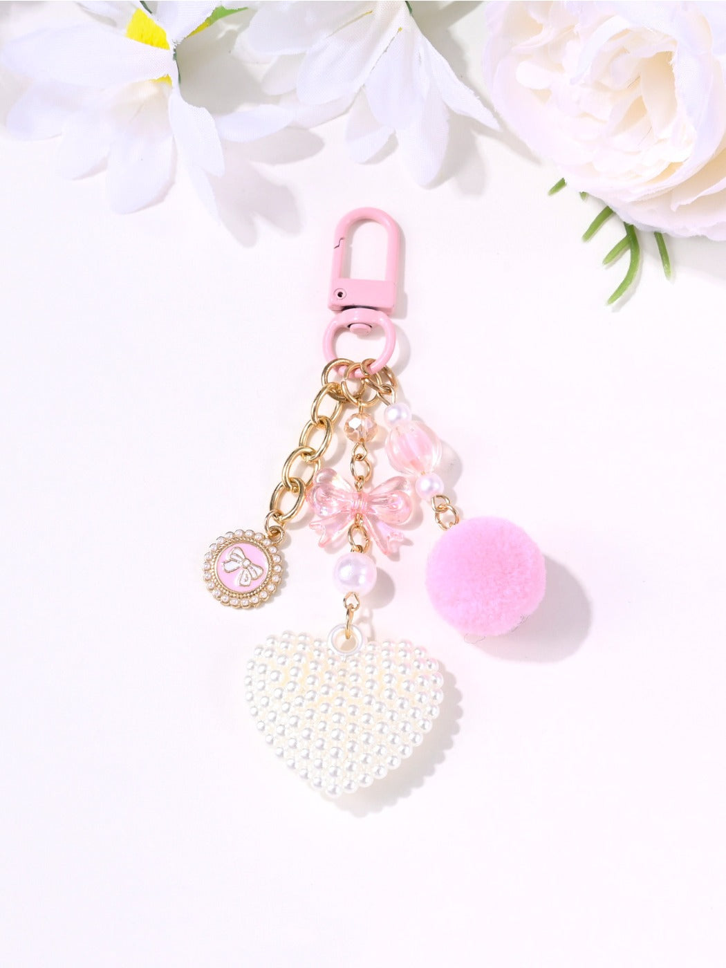 Pink heart-shaped keychain with a metallic ring and smooth finish