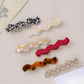 Beau exquisite wavy hair clip in glossy black, close-up view