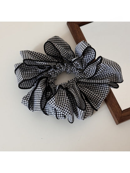 Close-up of fabric texture on Gifty classic checked scrunchie