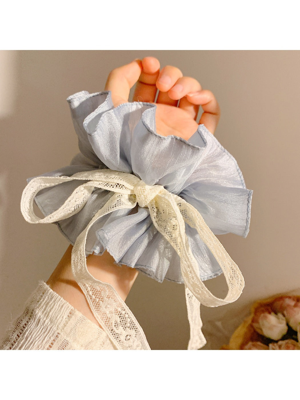 Close-up of Gifty pink bow scrunchie showing fabric texture and bow detail