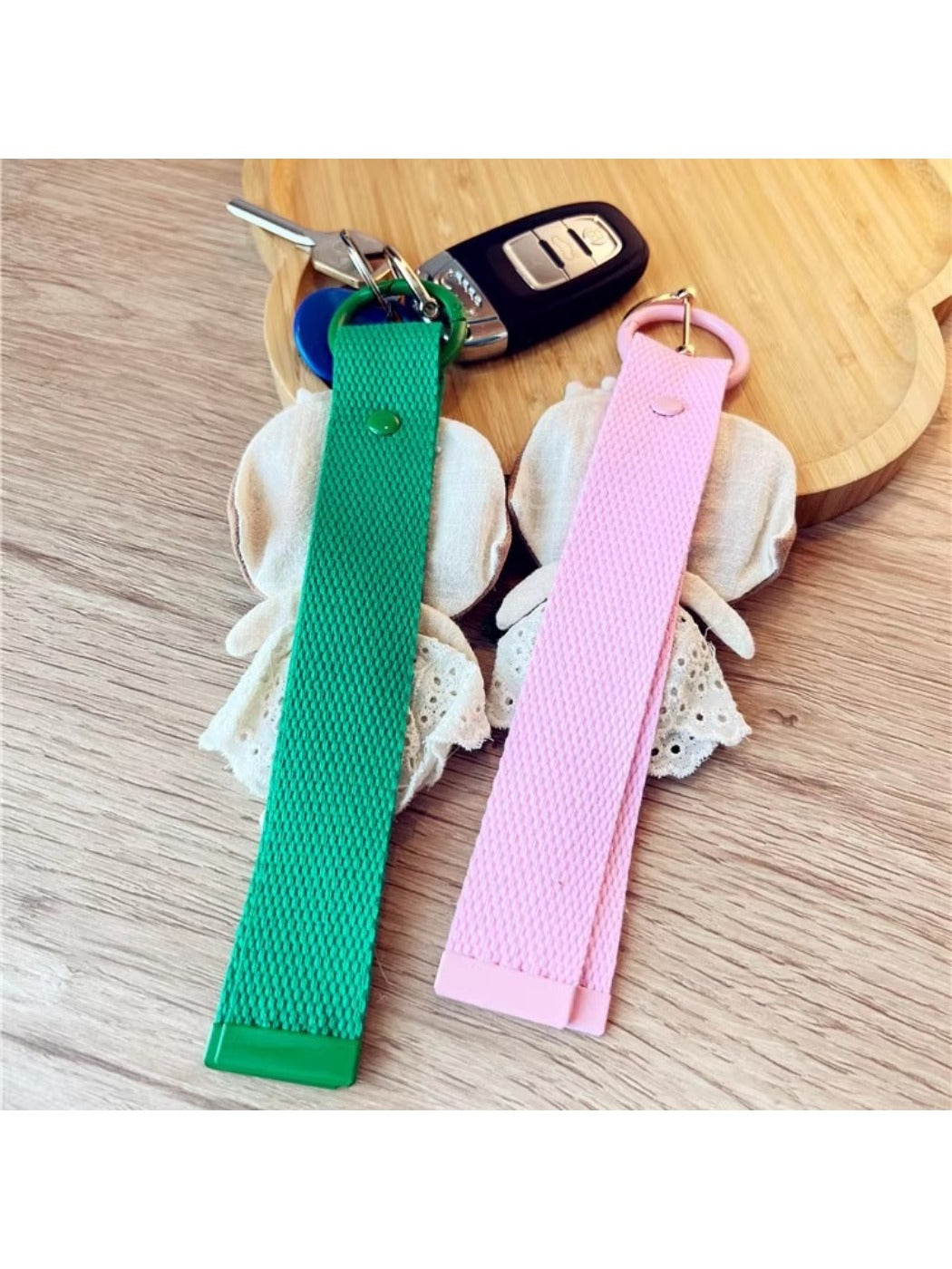 Fabric patchwork woven strap keychain held in hand displaying size and texture