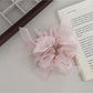 Gifty scrunchie worn on a wrist as a stylish accessory