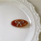 Beau oval butterfly hair clip positioned diagonally on white background