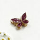 Beau butterfly hair clip in pastel green placed on a marble surface