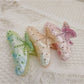 Close-up of Beau rainbow color claw clip with vibrant multicolor design