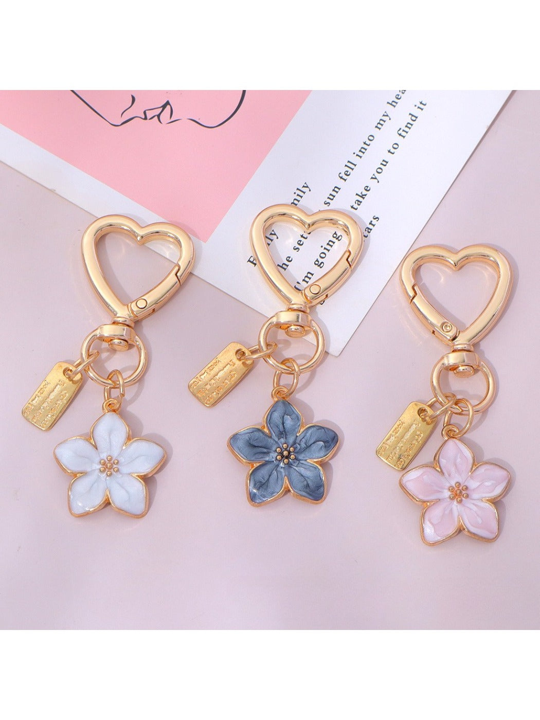 Keypus floral charm keychain hanging from a set of keys on a wooden surface
