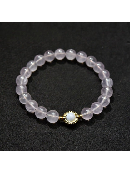 Lovra pastel beaded bracelet on a wooden surface, showcasing bead colors and smooth finish