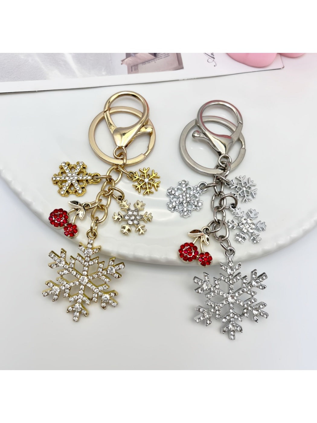 Snowflake pendant keychain hanging from a silver keyring with a white backdrop
