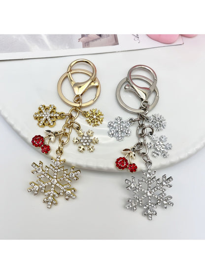 Snowflake pendant keychain hanging from a silver keyring with a white backdrop