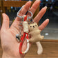 Bear keychain held in hand showing its compact size and softness