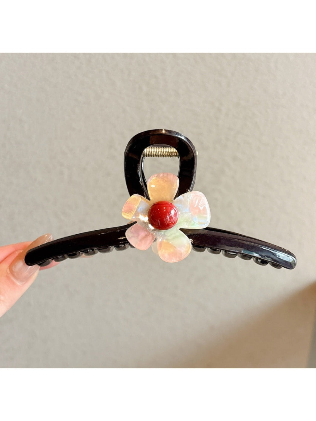 Side view of the pink flower claw clip showing the clasp mechanism