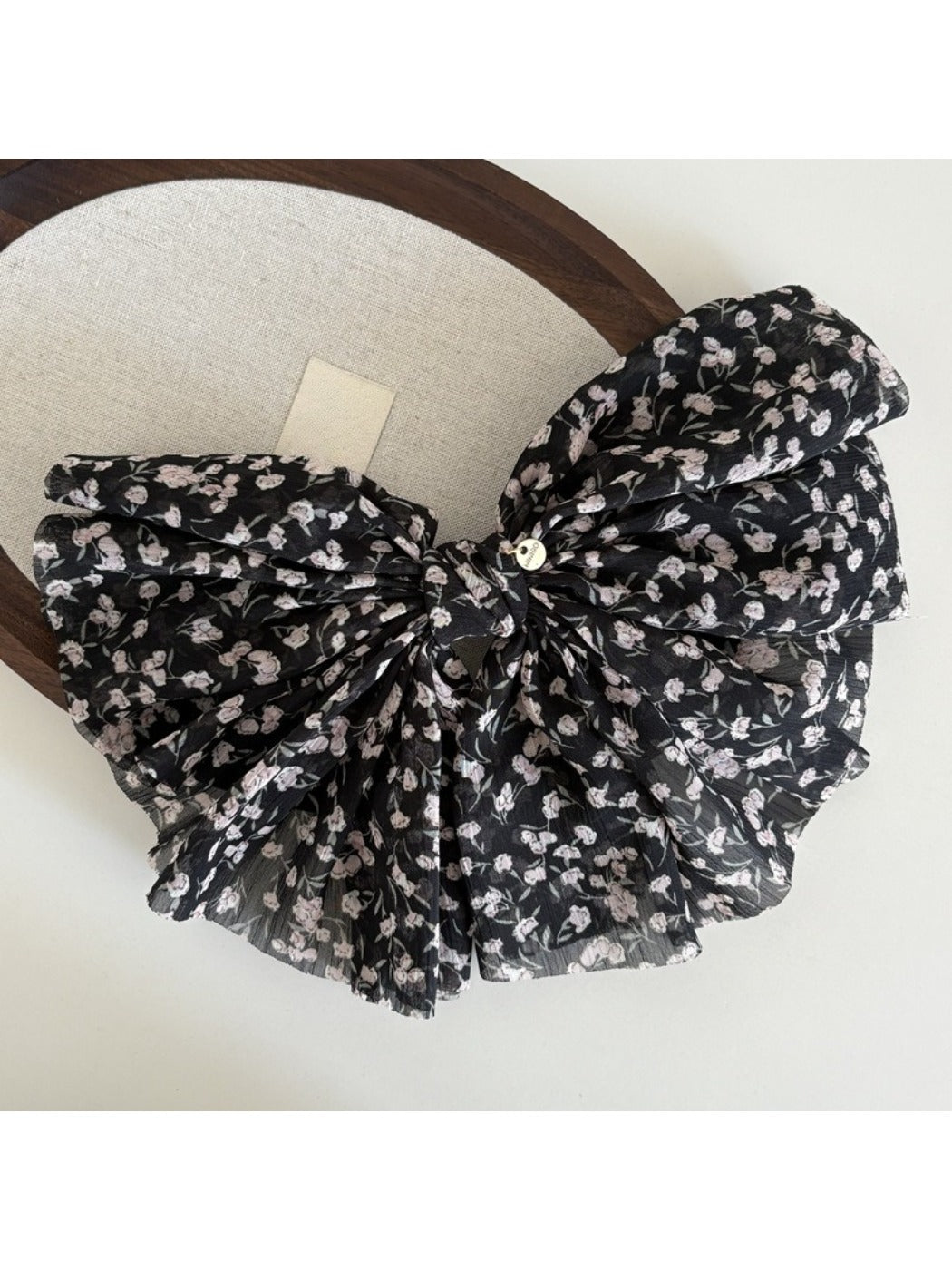 Beau chiffon bow hair clip displayed on white background with shadow