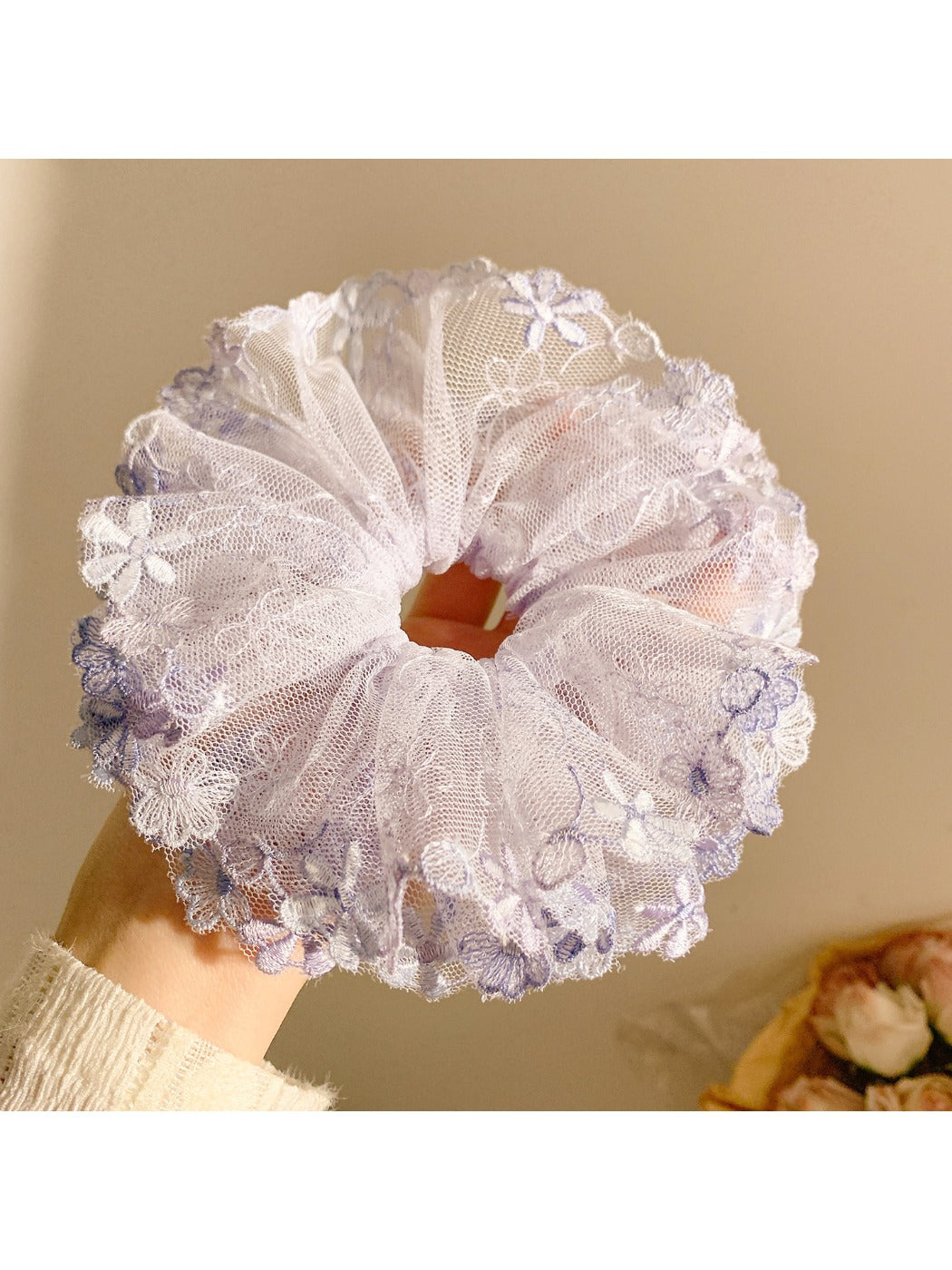 Gifty floral ruched scrunchie styled on a wrist showing fabric texture and colors