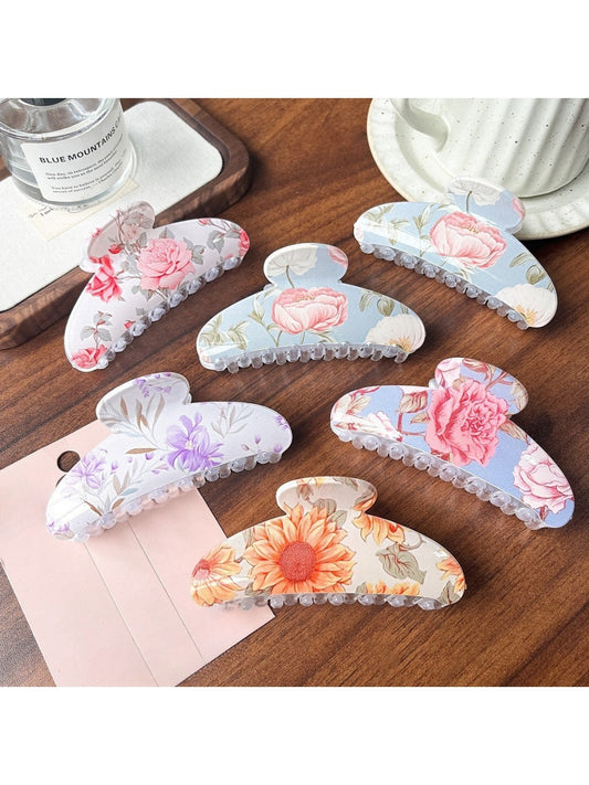 Close-up of Beau colorful flower pattern hair clip with vibrant pink and orange petals