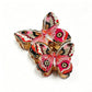 Close-up of airy red butterfly shaped hair clip with intricate wing details