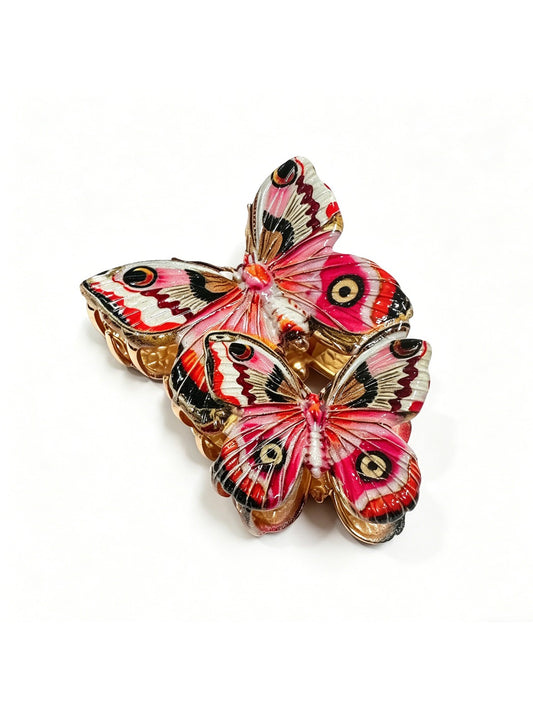 Close-up of airy red butterfly shaped hair clip with intricate wing details