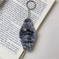 Colorful diamond-shaped pendant keychain on a black background emphasizing colors