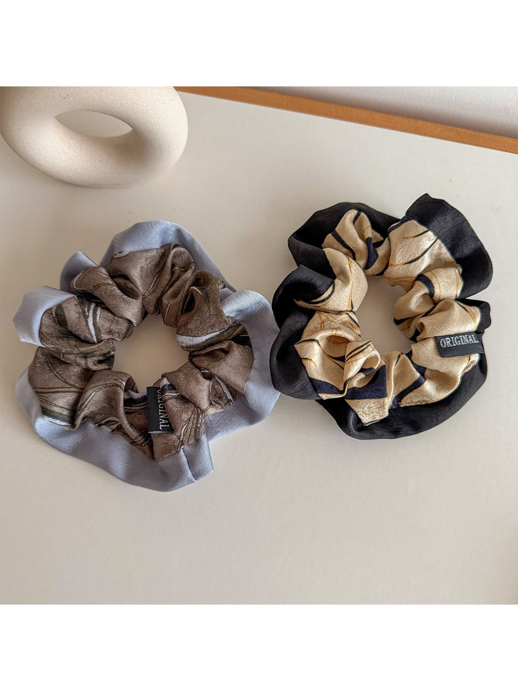 Side view of Gifty color block scrunchie highlighting fabric texture and elastic band