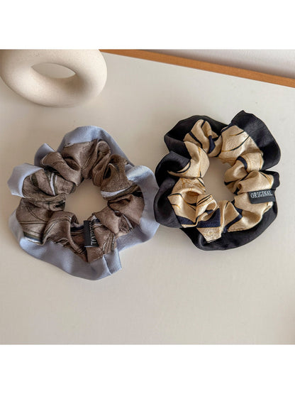 Side view of Gifty color block scrunchie highlighting fabric texture and elastic band