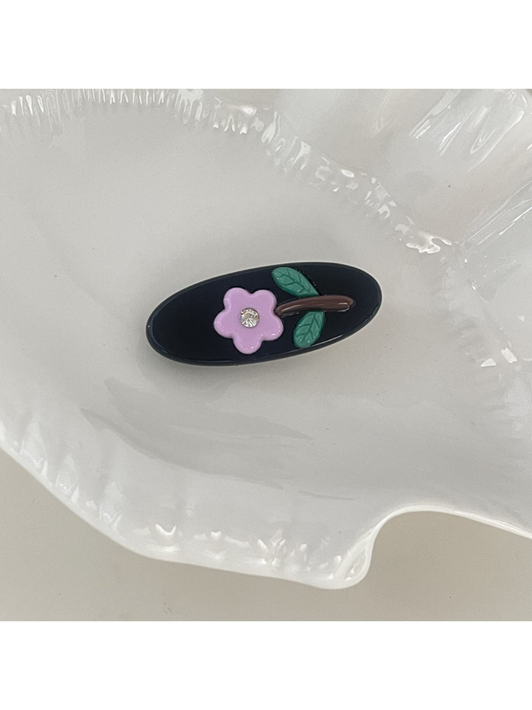 Beau hair clip displayed on a white background showing its oval shape and clasp