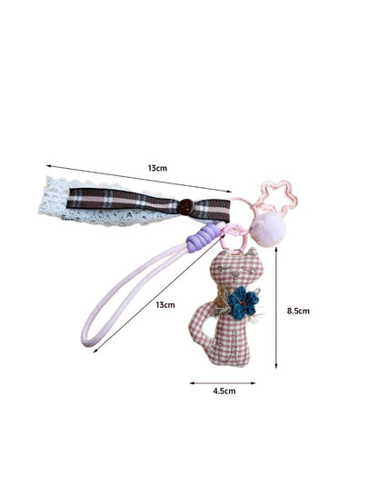 Side view of the cat shaped fabric keychain highlighting its thickness and stitching