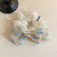 Side view of Gifty polka dot bow hair tie showing elastic band detail