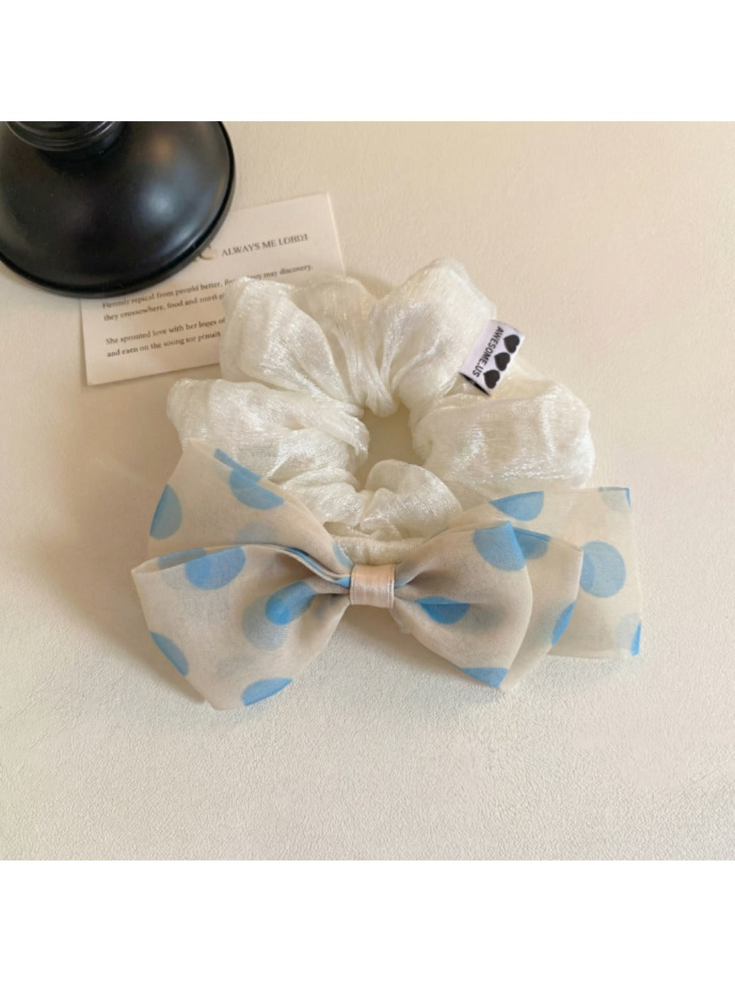 Side view of Gifty polka dot bow hair tie showing elastic band detail