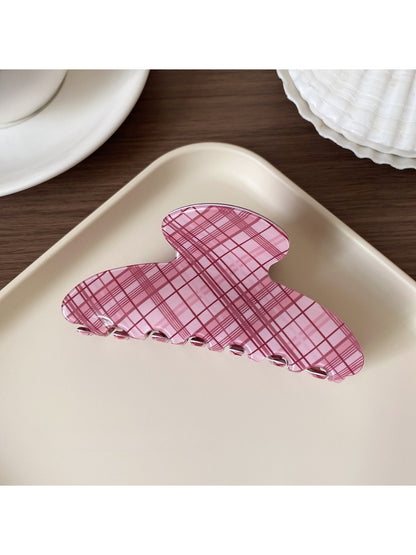 Beau pink plaid hair claw clip displayed on wooden surface