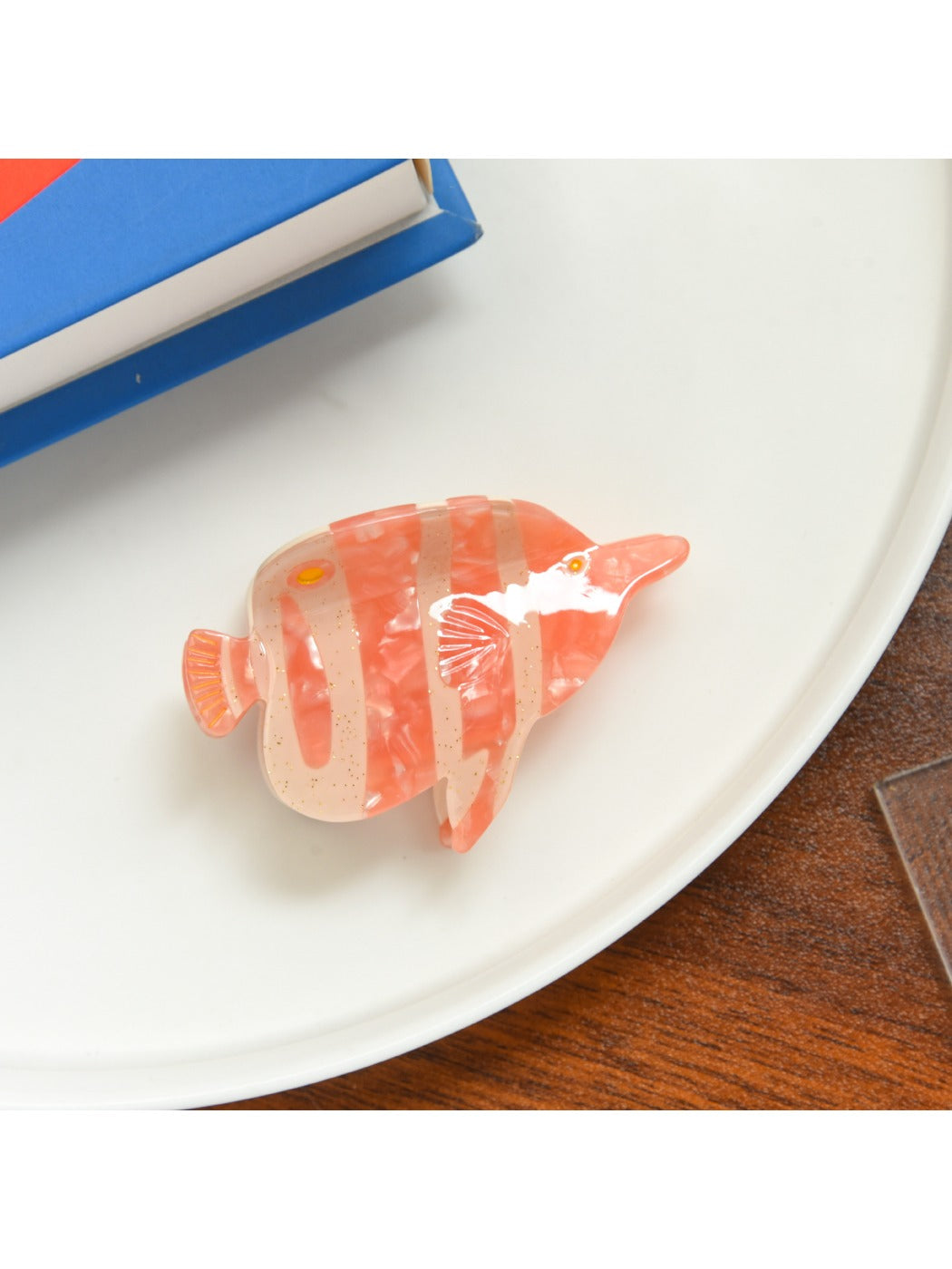 Beau tropical fish shaped hair clip shown with other colorful hair accessories