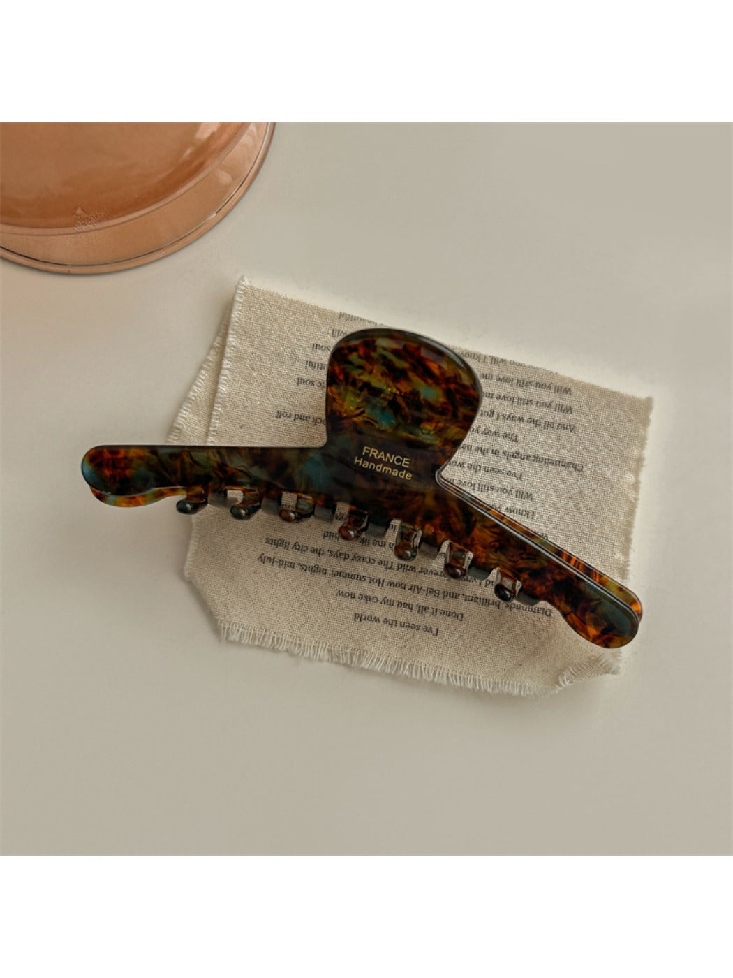 Beau chic acetate claw clip clipped into thick curly hair